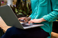 Woman Using a Credit Card for an Online Payment on a Laptop Woman Using a Credit Card for an Online Payment on a Laptop