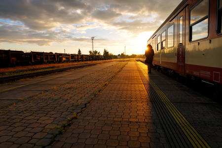 Train Standing by a Train Station Platform During Sunset