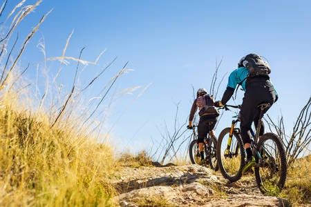 Two Mountain Bikers on a Trail in a Desert