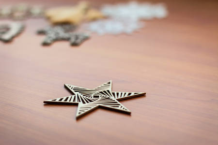Star Ornament with Other Christmas Decorations on a Wooden Table