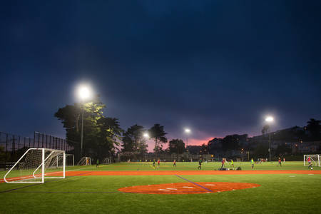 Night Time View of a Soccer Field with Young Players