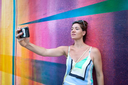 Woman Taking a Selfie in Front of a Spray Painted Wall