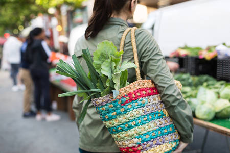 Rear View of a Woman Shopping for Fresh Vegetables at a Farmers Market