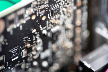 Close-Up View of a Black Circuit Board with Blurred Foreground