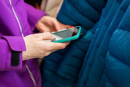 Woman Using a Cell Phone to Compare a Product Price