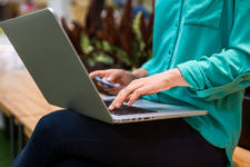 Hands of a Woman Using a Credit Card for an Online Payment Hands of a Woman Using a Credit Card for an Online Payment