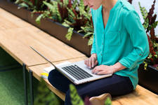 Female Freelancer Working on a Laptop in a Shopping Mall Female Freelancer Working on a Laptop in a Shopping Mall