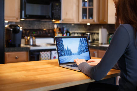 Woman Remotely Working from Home on a Laptop