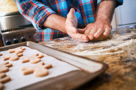Low-Angle View of a Man Baking Gingerbread Cookies at Home