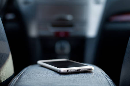 Shallow Depth-Of-Field Image of a Cell Phone Placed on Central Console of a Car