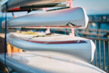 Detailed View of Paddle Boards Stacked up by a Lake