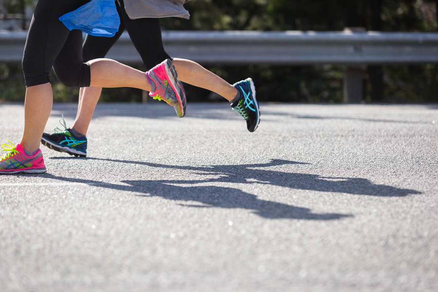 Low-Angle View of Two Runners Stock Photo - PixelTote