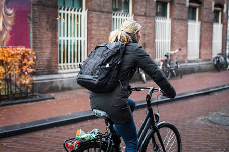 Woman Riding a Bicycle on a City Street
