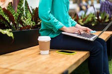 Woman with a Laptop Using a Credit Card for an Online Payment