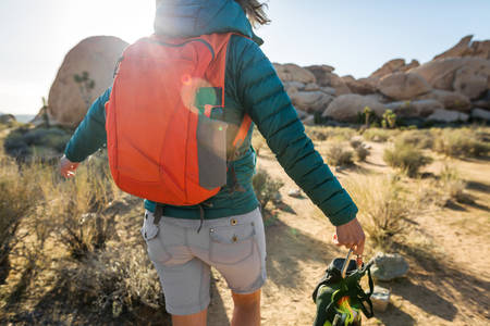 Joyful Woman with Climbing Shoes Hiking on a Desert Trail