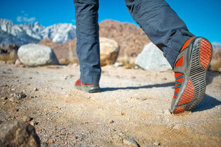 Low-Angle View of a Female Hiker on a Trail in the Desert