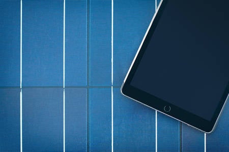 Overhead View of a Tablet Positioned on a Solar Panel