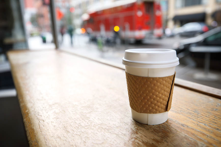 Paper Cup On A Wood Grain Table In A Coffee Shop With A Street View 