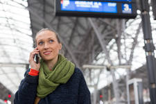 Woman Standing on a Railway Platform and Making a Phone Call Woman Standing on a Railway Platform and Making a Phone Call