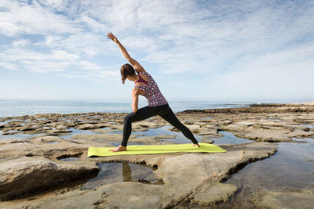 Focused Girl Practicing Yoga by the Ocean