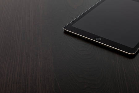 Detailed View of a Digital Tablet on a Black Table
