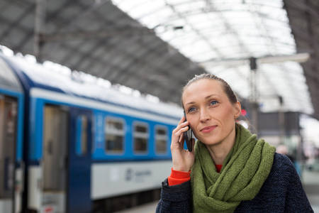 Woman Making a Phone Call in a Train Station