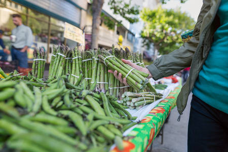 Woman Shopping for a Fresh Asparagus at a Farmers Market
