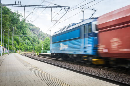Motion Blur Cargo Train Going Through a Railway Station